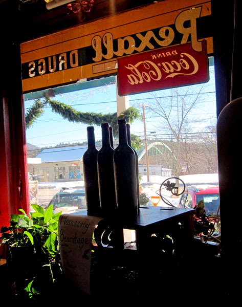 Looking at the old window above a stock of wine.
